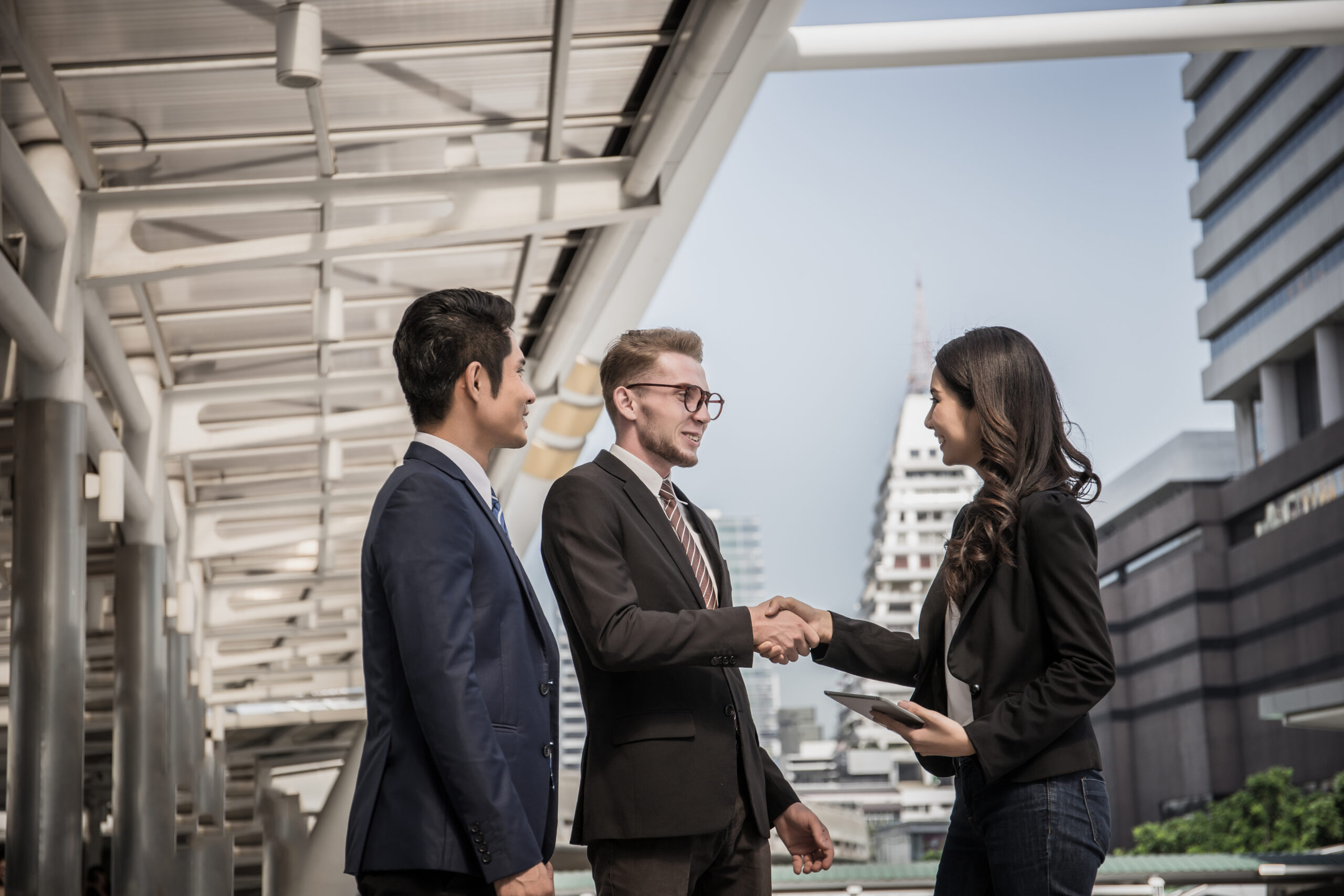 home business partner shaking hands and smiling while meeting in fron