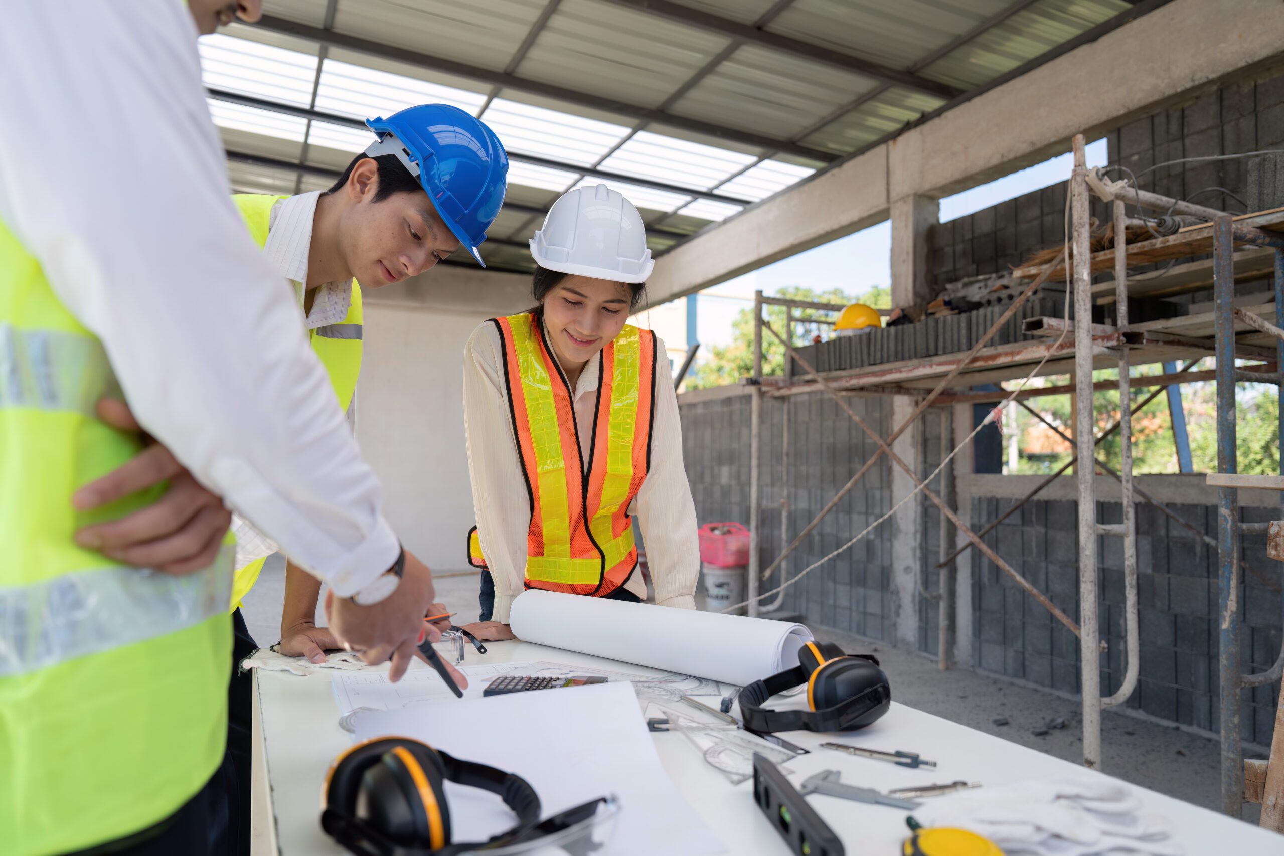 home team of engineer reviewing discussion blueprint at construction site, collaborative planning